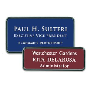 Blue and red plastic name tags with silver frames with engraved text.