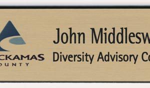 Full color gold name tag with printed logo and engraved name