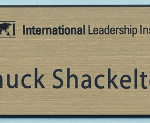gold name tag with engraved logo and text