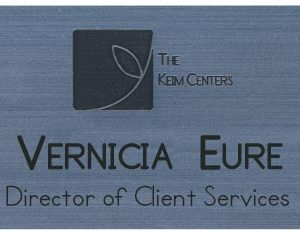 silver name tag with engraved logo and text