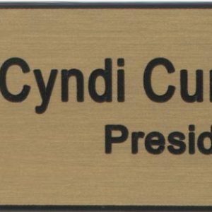 gold name tag with black engraved logo name and title