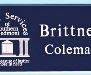 navy blue name tag with white engraved logo and name