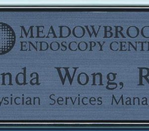 silver framed name tag with engraved logo and text