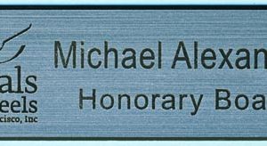 silver name tag with black engraved logo and name