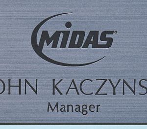 metallic silver pocket name tag with engraved Midas logo and text