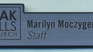 custom shaped silver name tag with black engrave logo and text