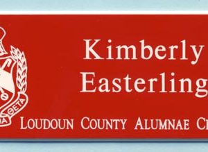 red engraved name tag with white engraved logo and text