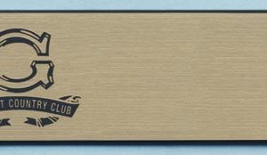 gold name tag with black engraved logo and text