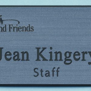 silver metallic name tag with engraved logo and text