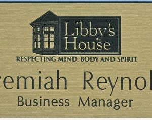 gold metallic name tag with engraved logo and text