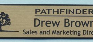 gold name tag with engraved logo and text