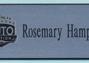silver name tag with engraved logo and name