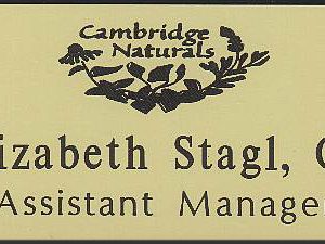 Ivory name tag with dark brown engraved logo and text