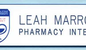 white name tag with full color logo and blue engraved names