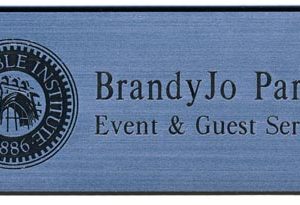 Silver metallic name tag with black engraved logo and text