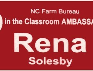 red name tag with white engraved logo and text