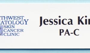 white name tag with full color printed logo and text
