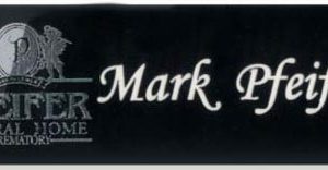 black name tag with silver foil logo and white engraved text