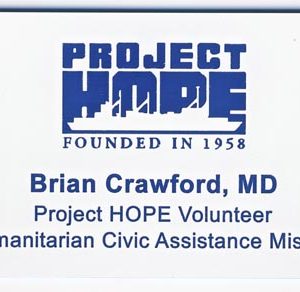 White name tag with blue engraved logo and text