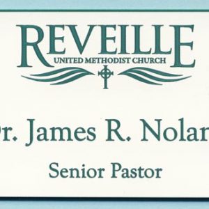 White name tag with green engraved logo and text