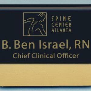 black pocket tag with gold engraved logo and text