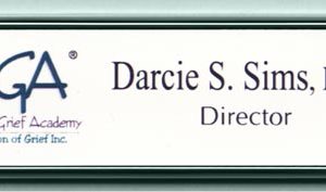 white name tag with full color printed logo and text and silver frame