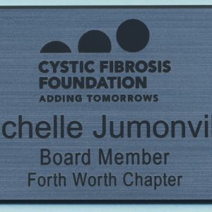 silver name tag with black engraved logo and text