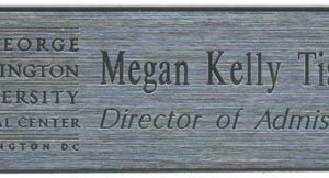 silver name tag engraved with black logo & text