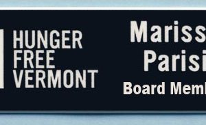 Black name tag with white engraved logo and text