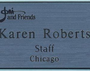 silver metallic name tag with engraved logo and text