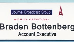 white name tag with printed logo and black engraved text