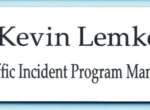 White name tag with black engraved text