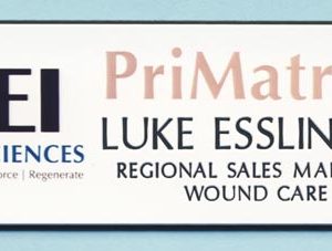 white name tag with printed logo and black engraved text
