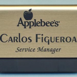 Engraved gold pocket tag with black engraved logo and text