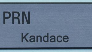 Engraved silver tag with black logo and text