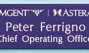 Purple name tag with white engraved logos and text