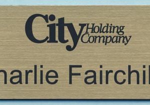 Engraved gold name tag with logo and text