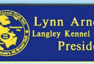 Engraved blue name tag with yellow logo and text