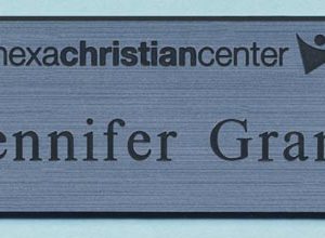 Engraved silver tag with black logo and text