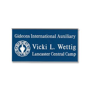 Blue name tag with white engraved Gideons International logo and names and titles.