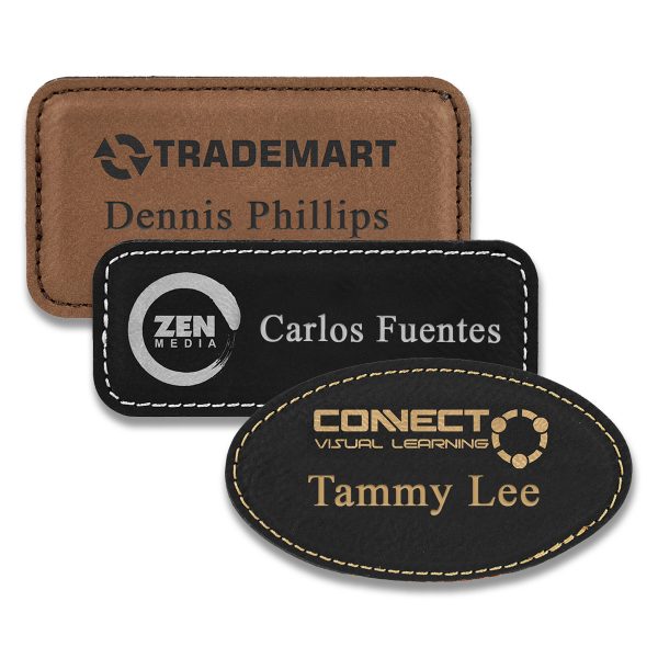Rectangle brown and black leather name tags with engraved logo and lines of text