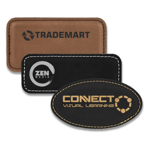 Rectangle and oval brown and black leatherette name tags with engraved logos.