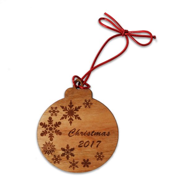 Cherry wood bauble Christ3mas tree ornament with customized engraved text phrase and tied with metallic red cord.