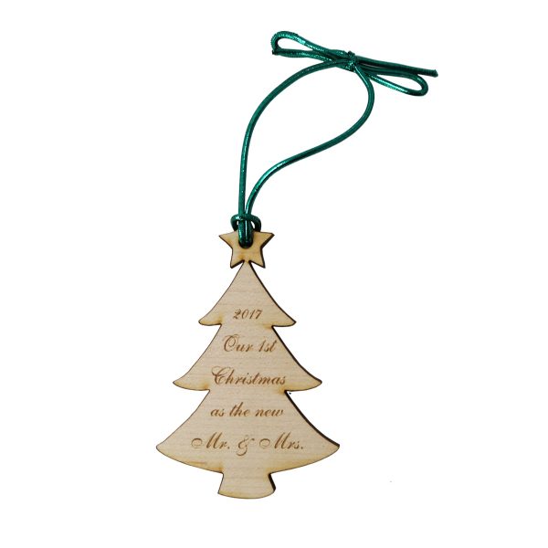 Birch wooden Christmas tree ornament with customized engraved text phrase and tied with green metallic cord for hanging.