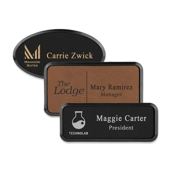 Framed rectangle and oval brown and black leatherette name tags with engraved logo and lines of text