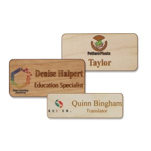 Full color wooden name tags with full color printed logos and engraved names and text on fine-grain wood.