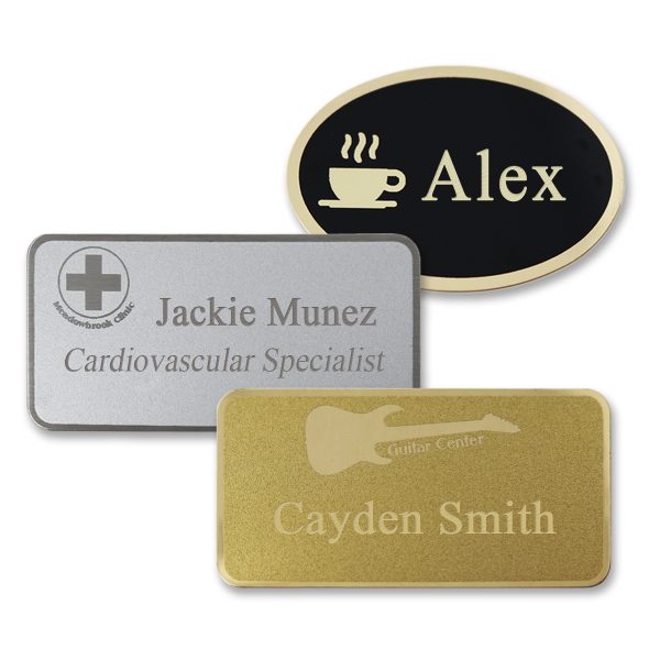 Metal name tags with engraved logos and text, on black metal with gold plating, silver metal with silver plating, and gold metal with gold plating.